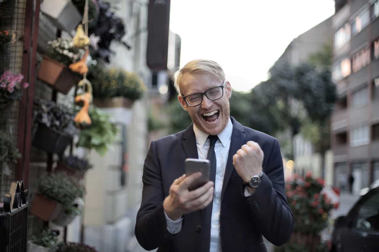 Person Looking at Phone and Cheering Person Looking at Phone and Cheering