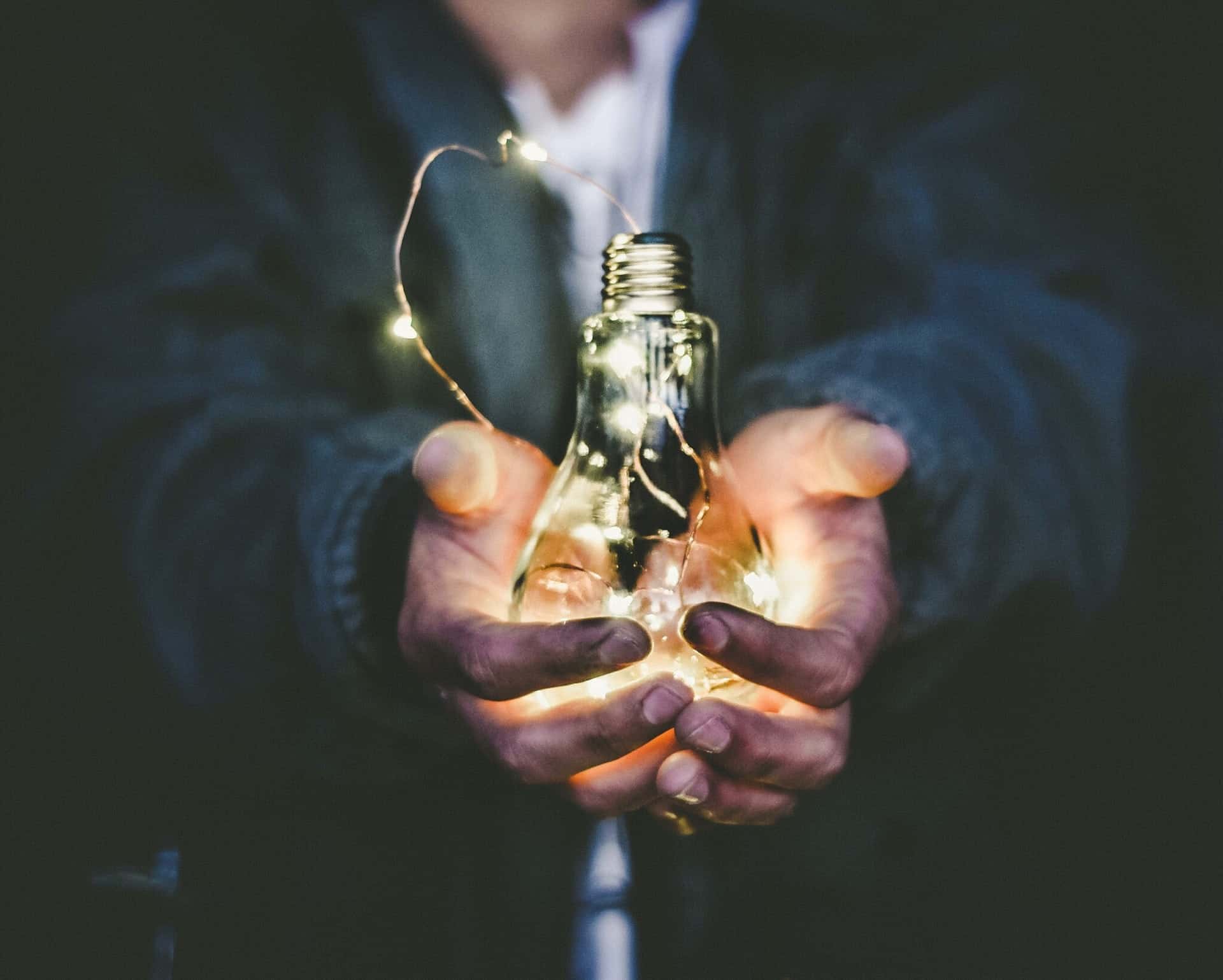 Man Holding a Light Bulb Man Holding a Light Bulb