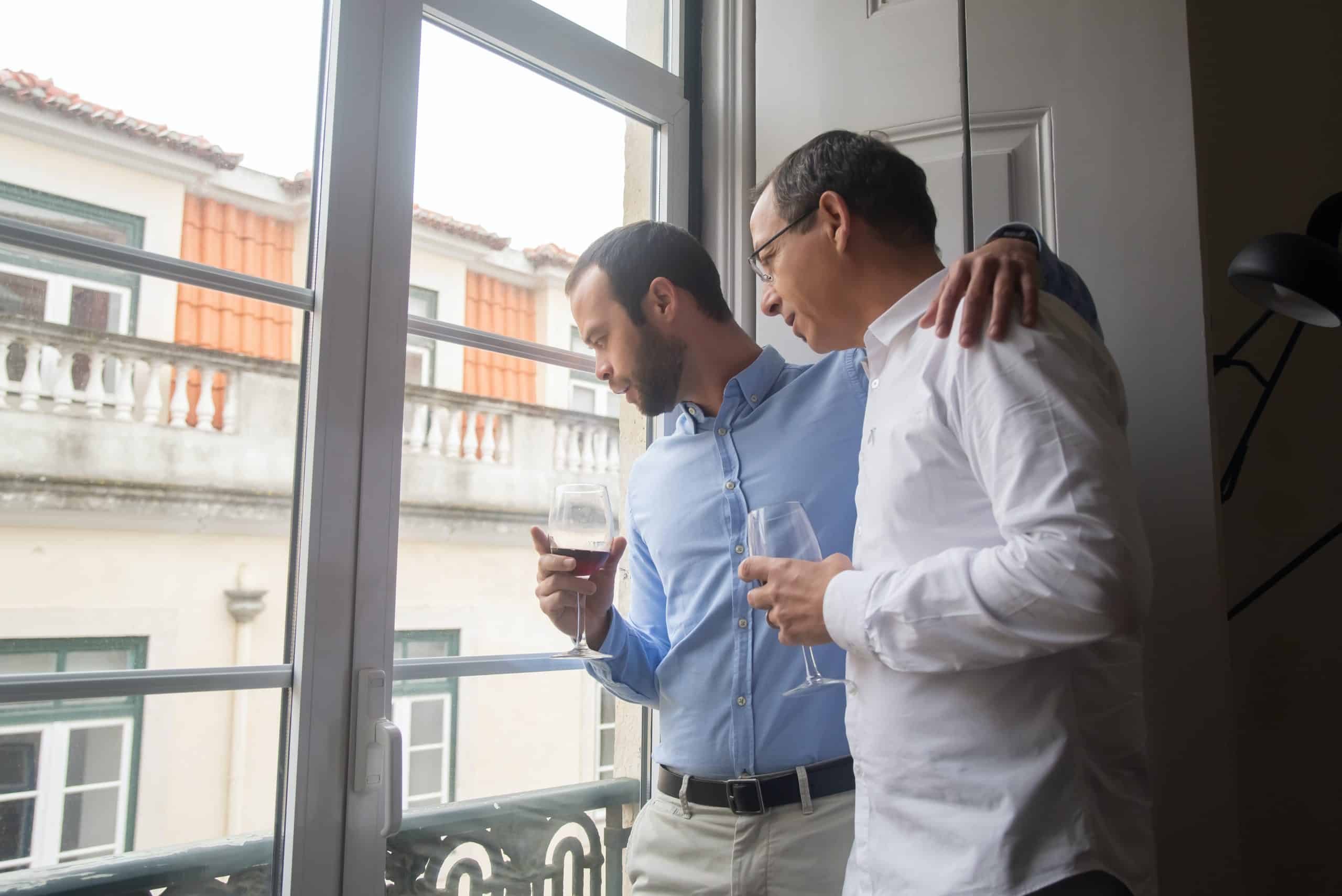 two guys looking out window two guys looking out window