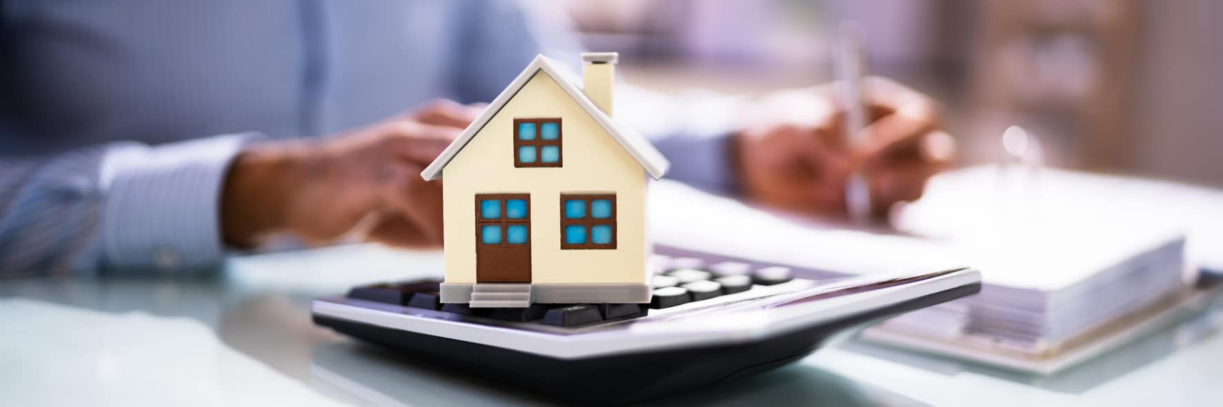 Home on calculator representing real estate news Home on calculator representing real estate news