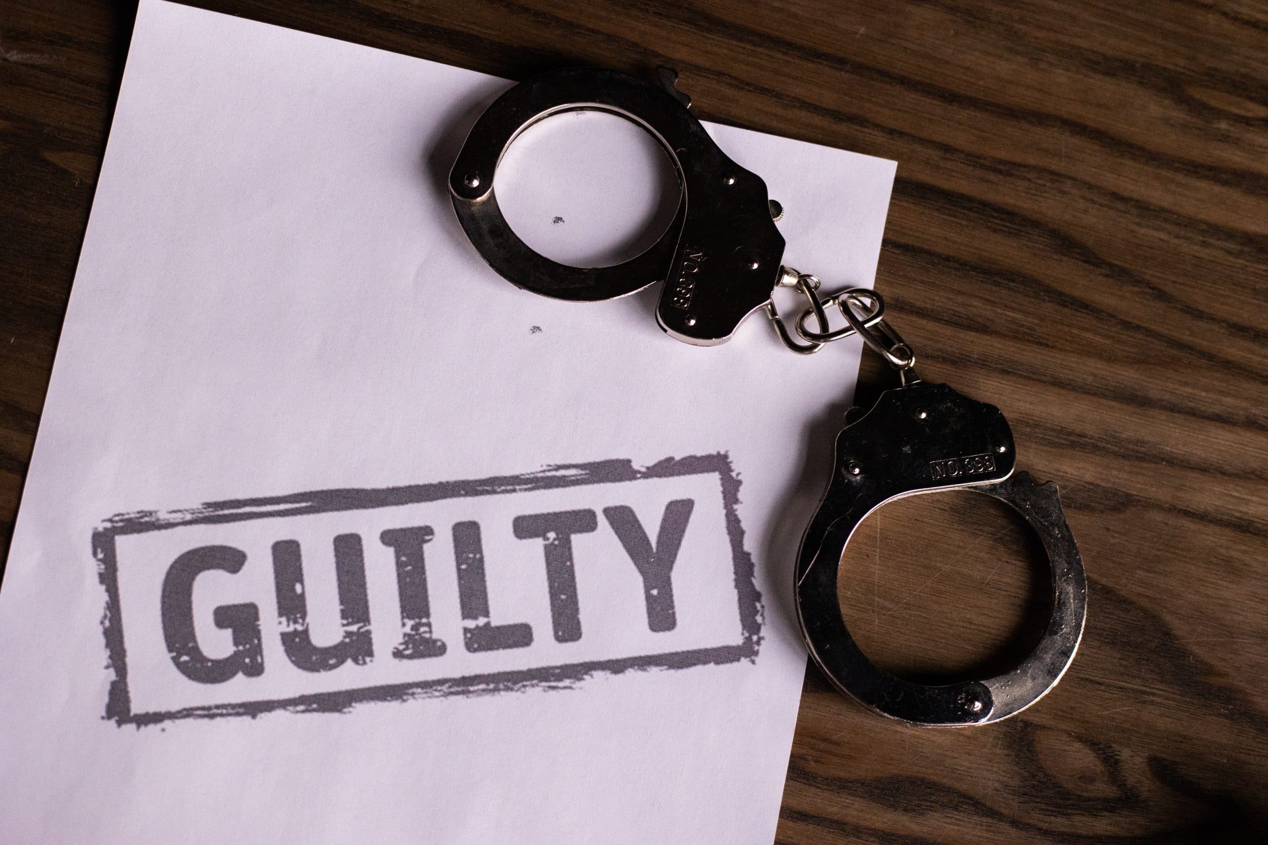 guilty handcuffs fraud