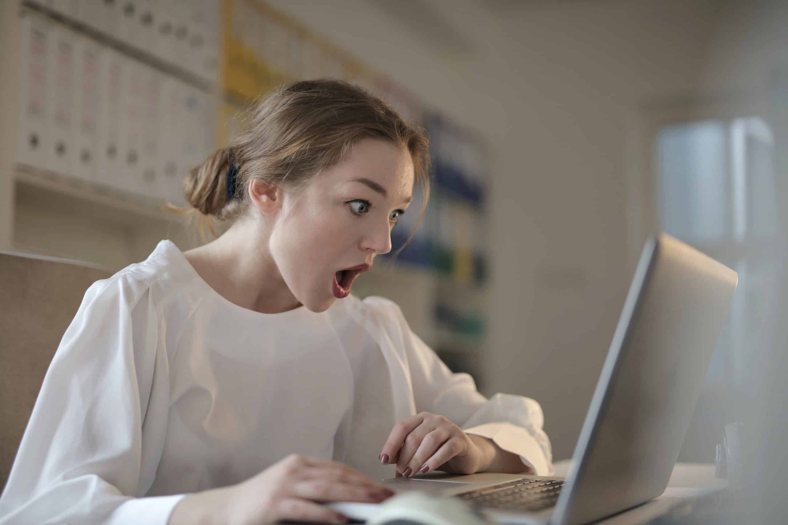 shocked face looking at computer
