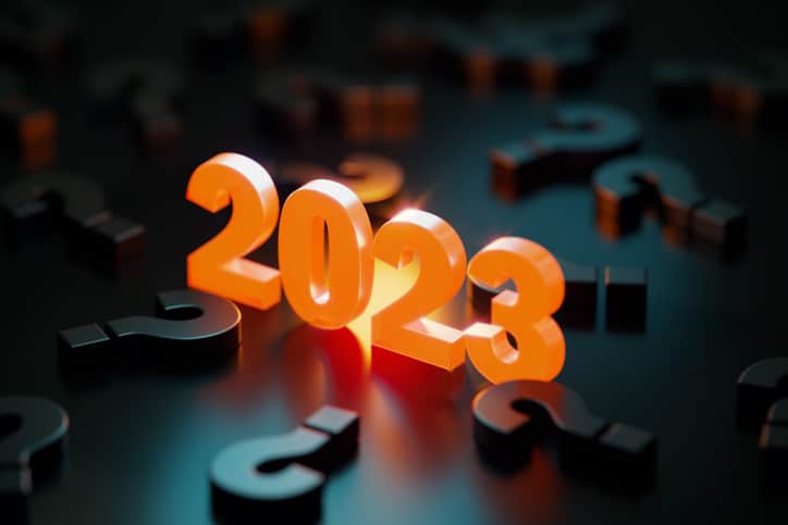 2023 Concept – Yellow 2023 Glowing Amid Black Question Marks On Black Background