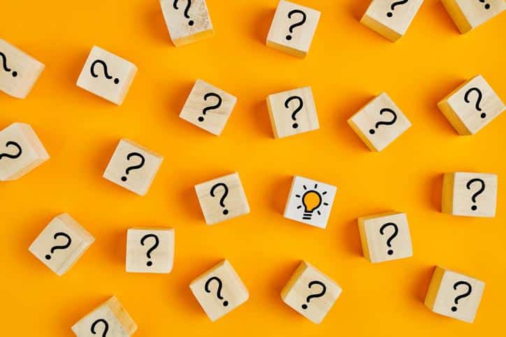 Concept of to find a creative idea or problem solving. Question mark and light bulb icons on wooden cubes