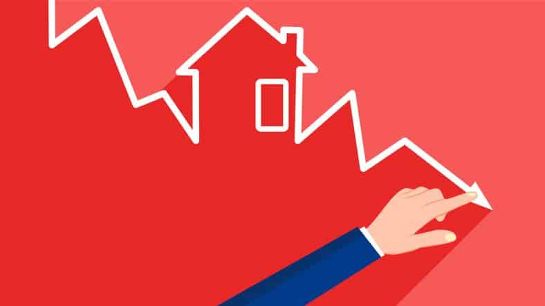 Businessman pointing to a downtrend graph. The concept of real estate or business is in crisis