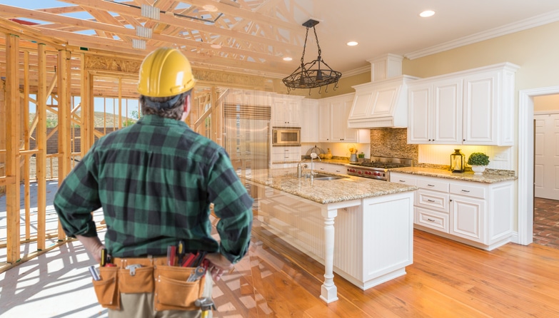 Contractor Standing In Front Custom Kitchen Construction Framing Gradating Into Finished Build