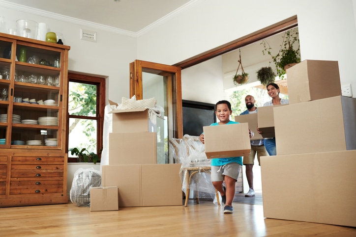 Young family moving boxes into new home as they start over in a new city