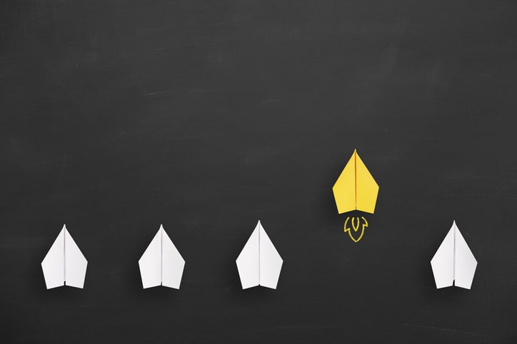 Change concepts with yellow paper airplane leading among white