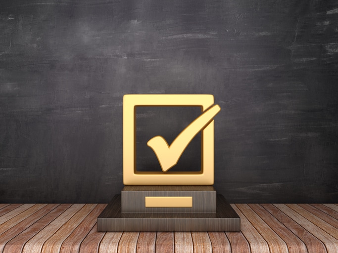 Trophy with Check Box on Wood Floor – Chalkboard Background – 3D Rendering