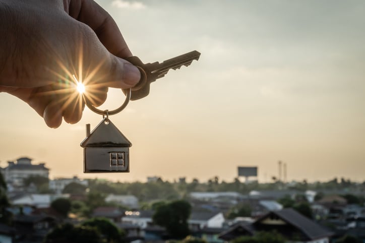 House model and key in home insurance broker agent hand or in salesman person. Real estate agent offer house, property insurance and security, affordable housing concepts