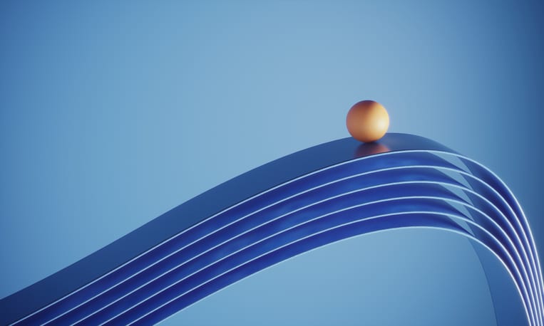 Orange Colored Ball Standing On Top Of The Ribbons