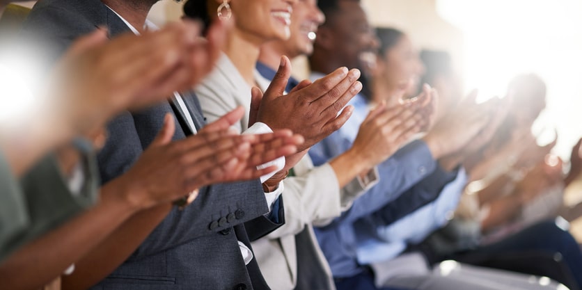 Cropped shot of an unrecognizable diverse group of businesspeople applauding while sitting in the boardroom during a presentation