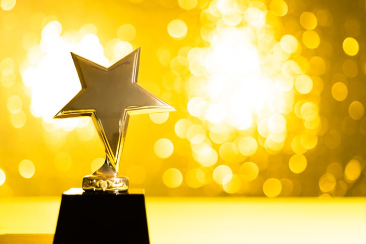 Star trophy on shiny yellow background
