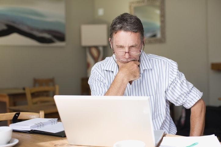 Serious businessman using laptop