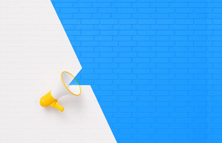 Yellow Megaphone on White and Blue Wall Background Company Announcement Hire