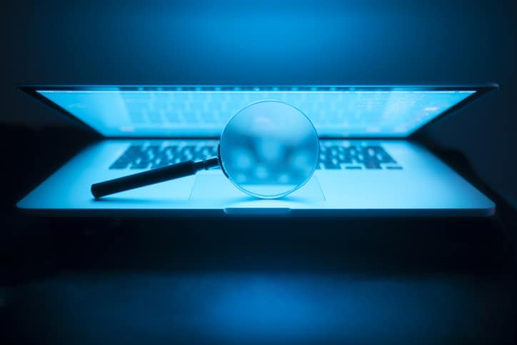 Magnifying glass in the laptop in the dark