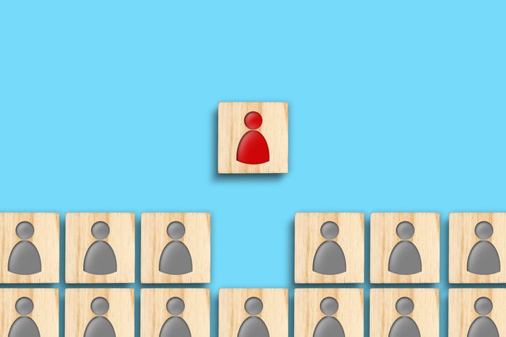 Wooden blocks with gray and red human icons. Teamwork. The concept of leadership, success. Career growth. Promotion CEO Real Estate Brokerage