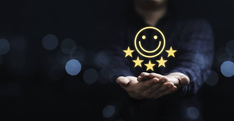 Businessman holding smile icon for the best evaluation , customer satisfaction concept. Happy Customers Chief Customer Officer Real Estate