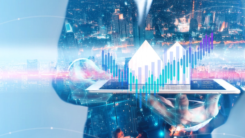 Businessman holding tablet with city hologram show a financial stock market increase profit graph in cyber punk theme Blockchain Real Estate