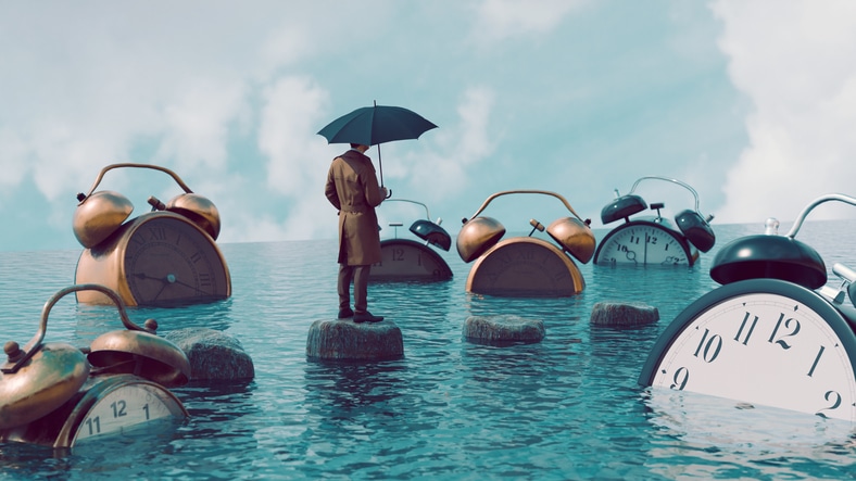Big alarm clocks are in the water and man with umbrella watches them Mortgage Delinquency Late Payment