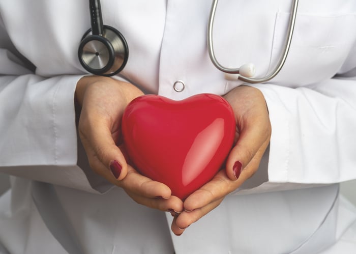 Medicine doctor holding red heart shape in hand, medical concept stock photo Health Priority Real Estate