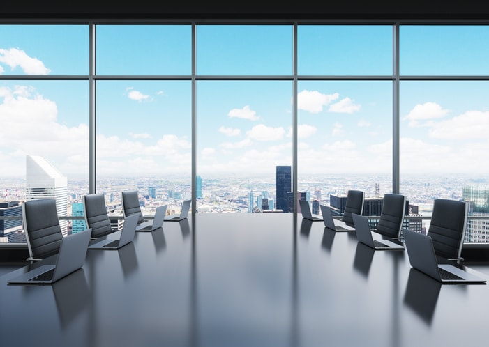 room equipped by laptops in a panoramic office Board of Directors Appointment Real Estate