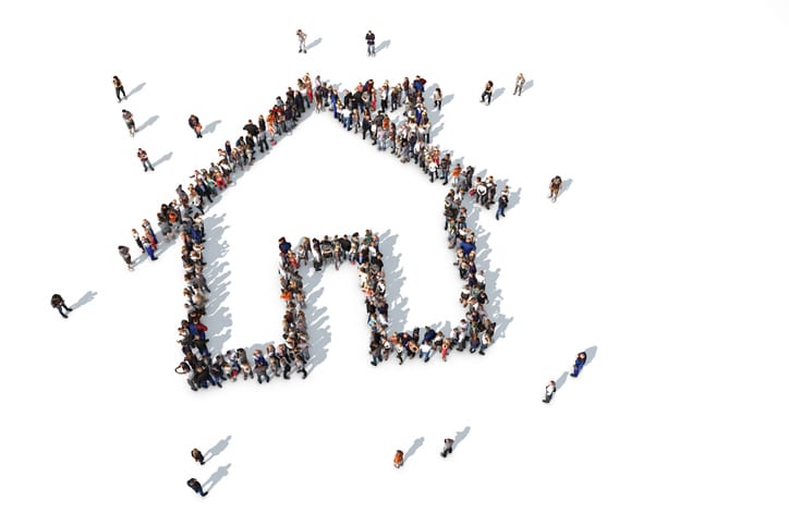 Group of people forming a house icon