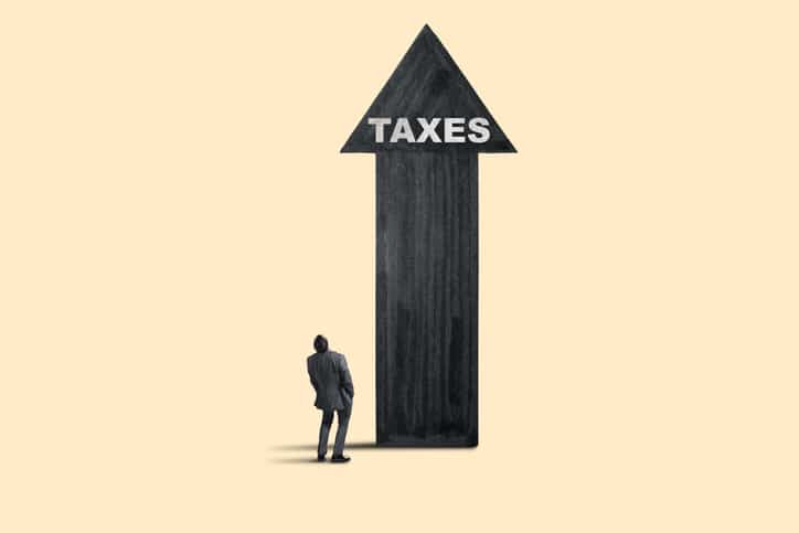 Man Looks Up At Arrow Representing Increasing Taxes Rising Taxes